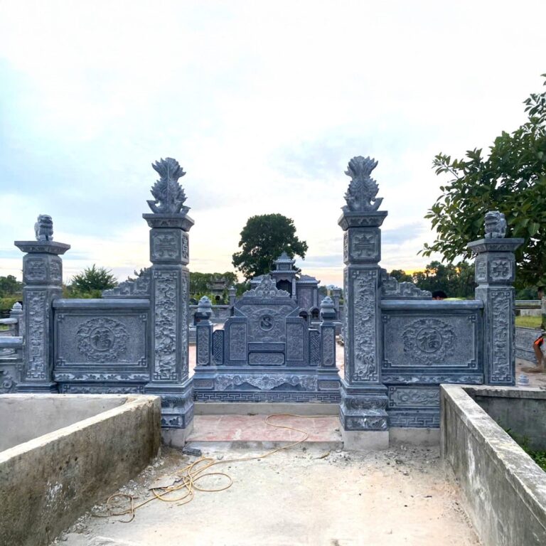 Cổng trụ đá xanh chạm nghê và bình phong chạm hoa văn ở lối vào khu lăng